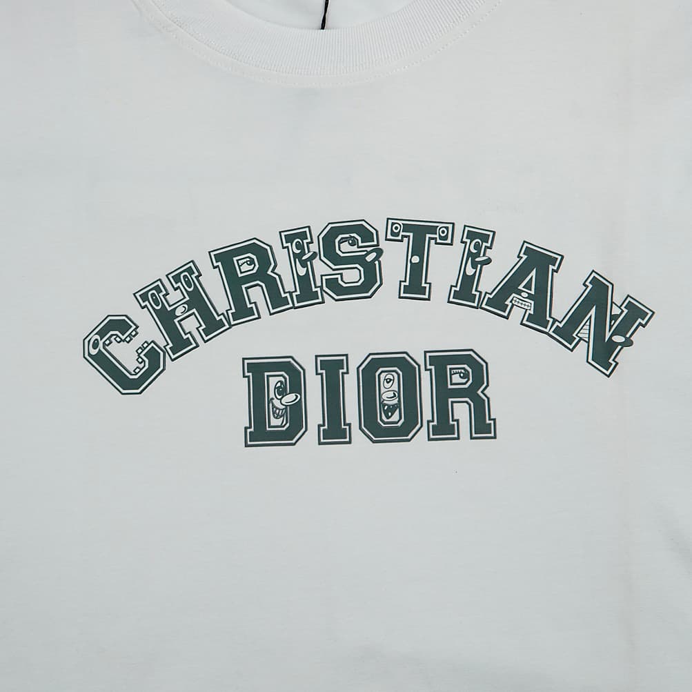 White Christian Dior t-shirt with dark green collegiate logo graphic, short sleeves, luxury unisex style.