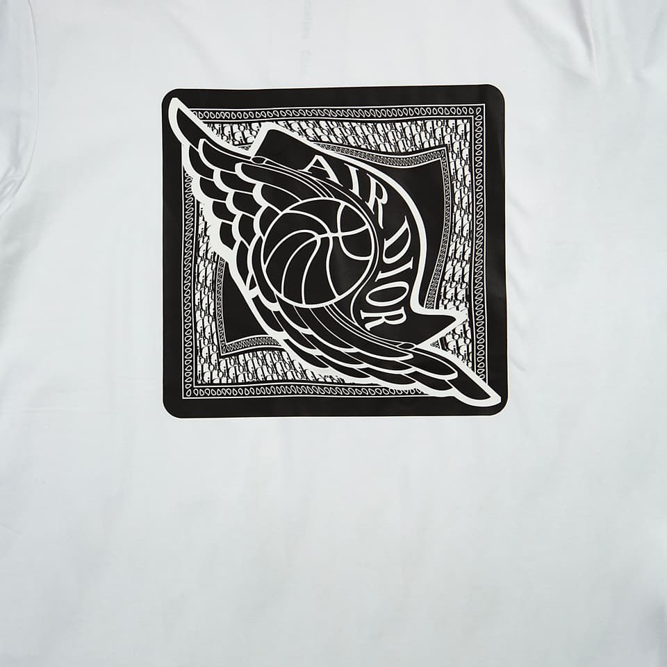 White Christian Dior x Jordan t-shirt with black and white Wings logo graphic patch, luxury unisex wear.