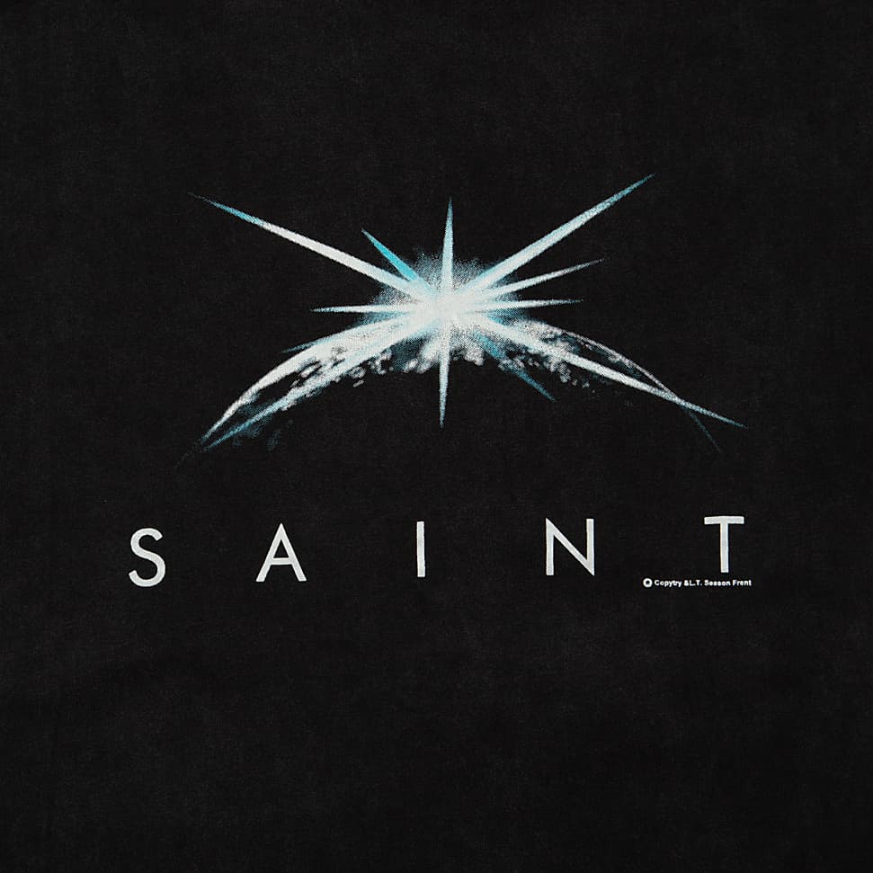 A black, vintage-look t-shirt with a faded/washed finish. It features a striking graphic print on the front, centered below the crew neck.