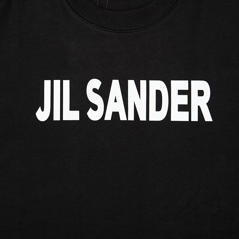 This is a minimalist, luxury short-sleeved T-shirt from the German fashion house Jil Sander. It embodies the brand's signature clean, understated aesthetic.