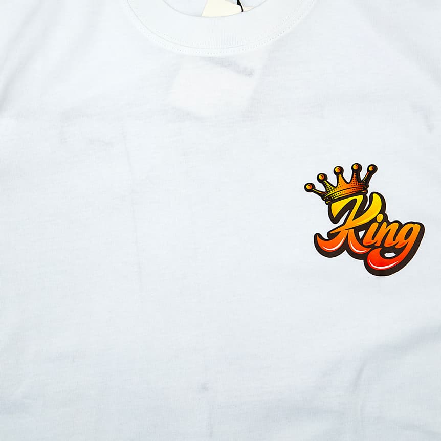 White t-shirt with small stylized "King" script and crown graphic on chest, short sleeves, unisex streetwear.