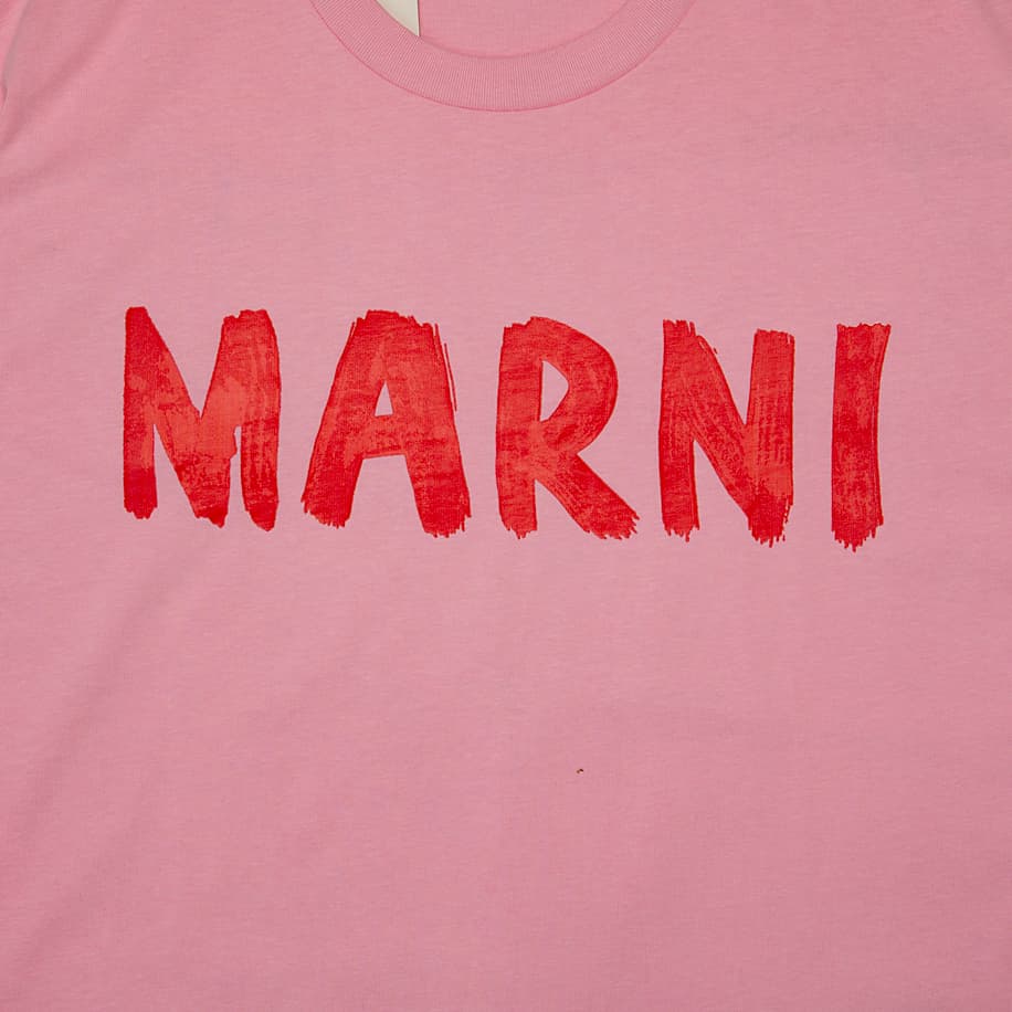 Pastel Pink Marni t-shirt with large red brushstroke logo graphic on chest, short sleeves, designer unisex streetwear.