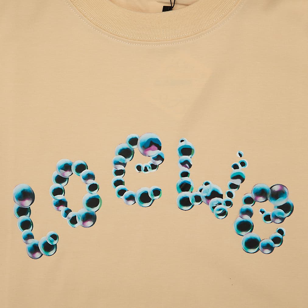 Tan Loewe t-shirt with large blue/black animal print bubble logo on chest, short sleeves, luxury unisex designer wear.