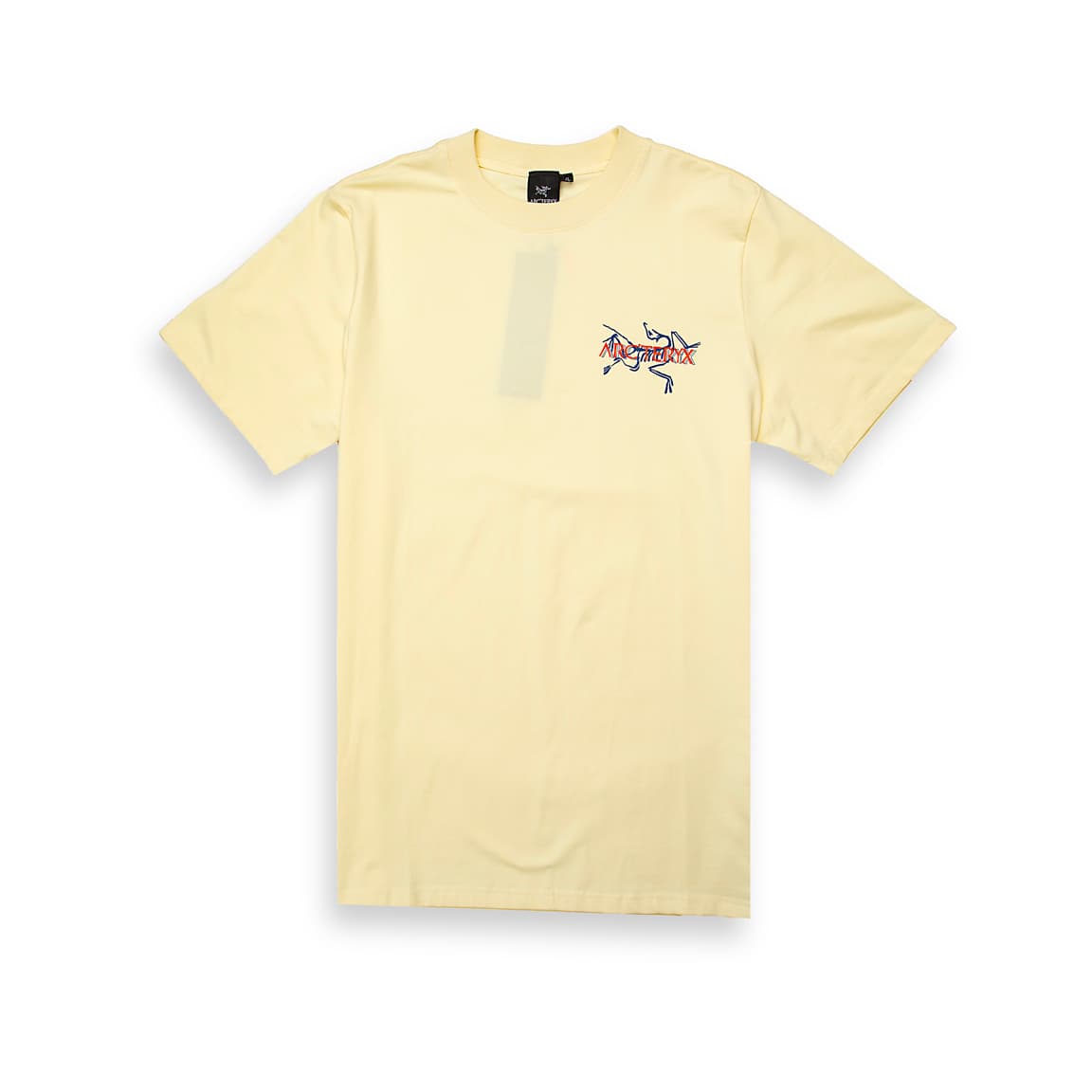 Cream Arc'teryx t-shirt with small multi-colour outlined fossil logo on chest, performance cotton, unisex outdoor wear.