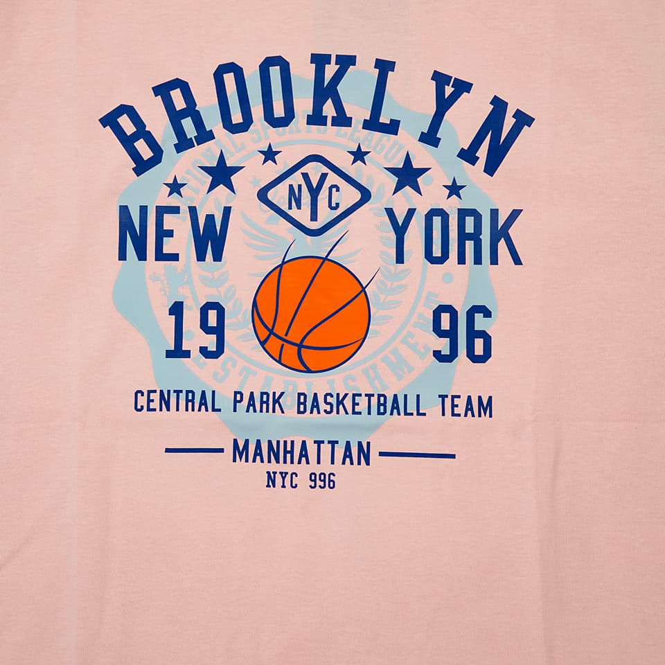 This is a casual, relaxed-fit sleeveless t-shirt (or tank top) featuring a vintage-style athletic graphic design inspired by New York City basketball culture.