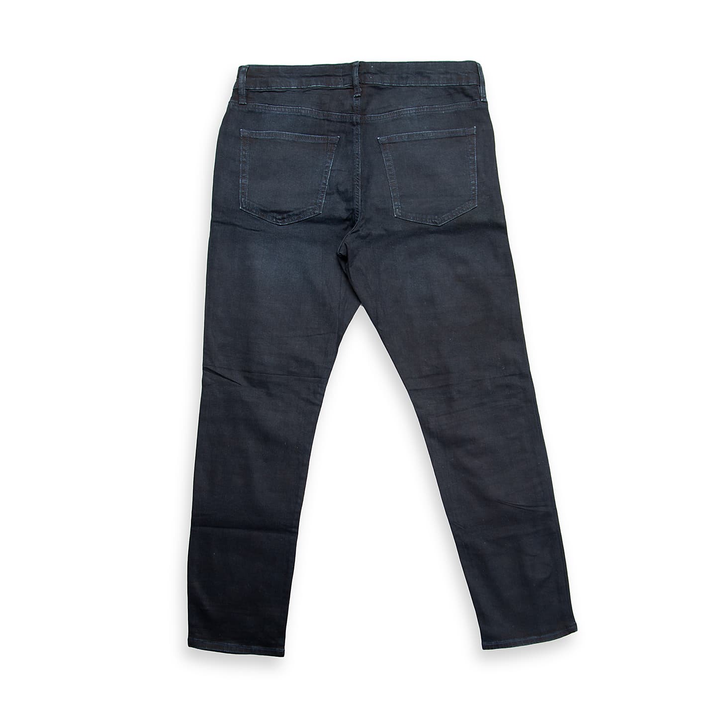 These are a pair of modern slim-fit jeans in a deep, rich indigo denim with a subtle wash and fading effect, primarily on the thighs.
