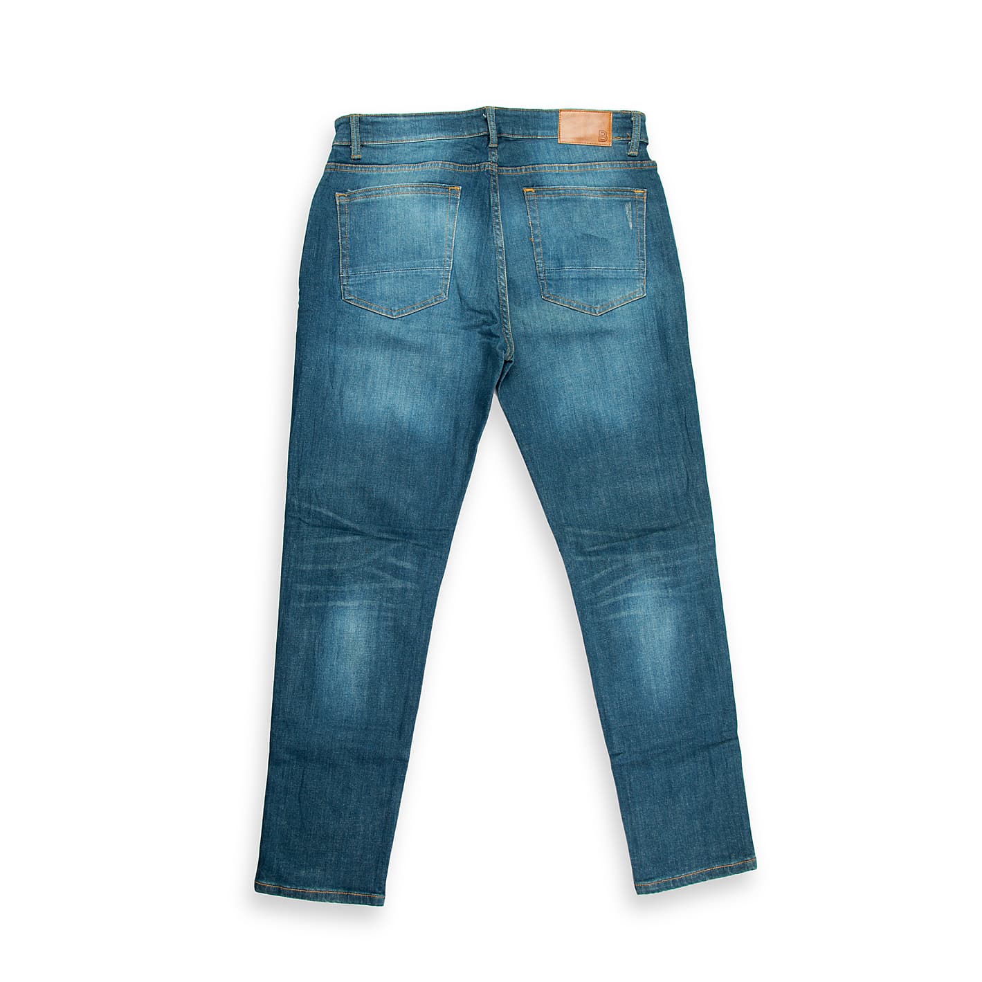These are a pair of straight or slim-straight fit denim jeans featuring a medium blue wash and significant factory distressing.