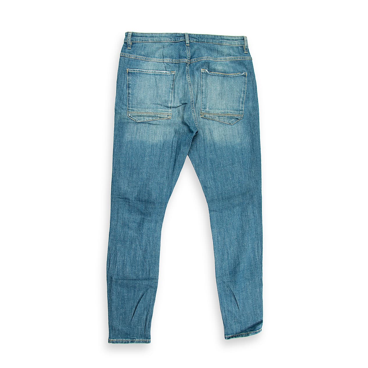 These are a pair of skinny-fit jeans featuring a distressed medium/vintage blue wash. The denim has a slight textural grain and natural fading across the thighs and seat, giving them a worn-in, authentic look.