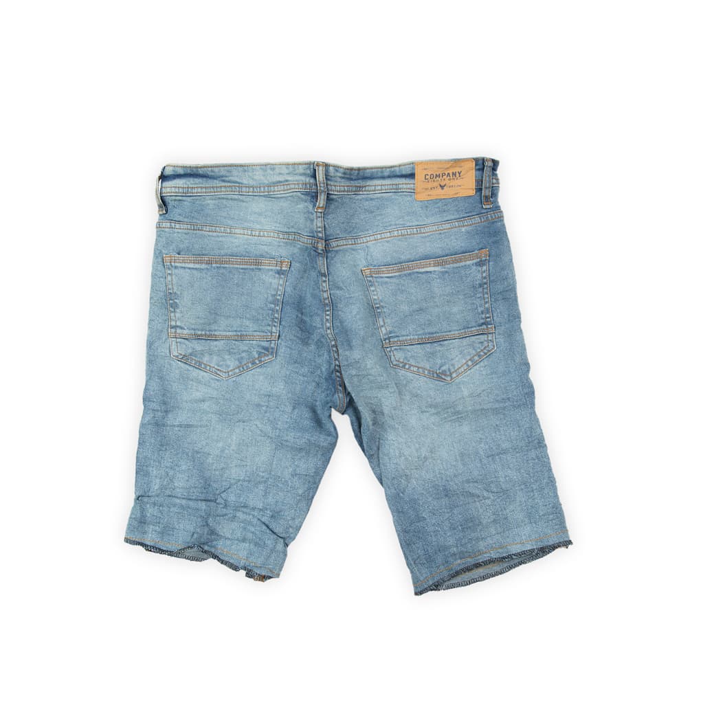 These shorts are designed for an edgy, relaxed summer look. They feature a pale, light blue wash with natural fading and a pronounced crinkle/wrinkle effect across the fabric.