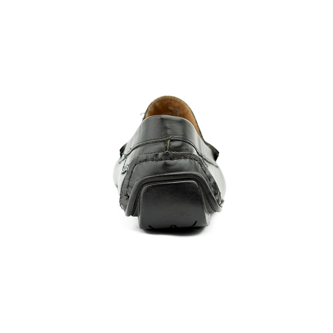 The Midnight Drive Loafer is a sophisticated, classic men's slip-on shoe. It features a traditional penny loafer silhouette with a soft, supple black leather construction, ideal for comfortable, elegant wear.