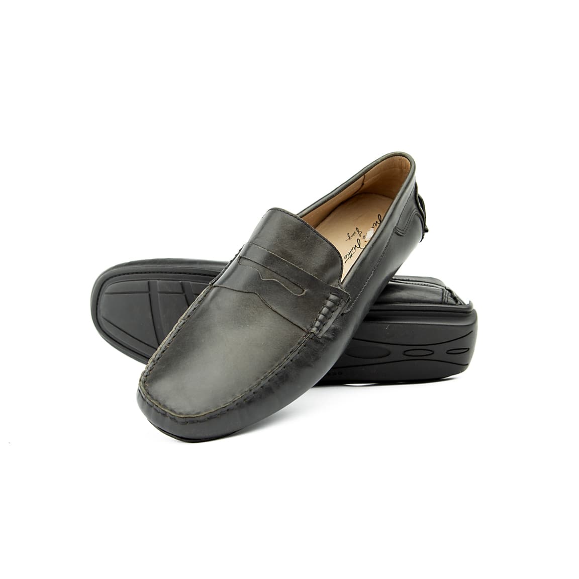 The Midnight Drive Loafer is a sophisticated, classic men's slip-on shoe. It features a traditional penny loafer silhouette with a soft, supple black leather construction, ideal for comfortable, elegant wear.