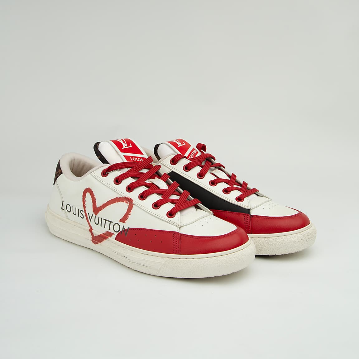 The LV Trainer Sneaker is a luxury low-top sneaker that blends high-fashion craftsmanship with a retro basketball and skate shoe aesthetic.