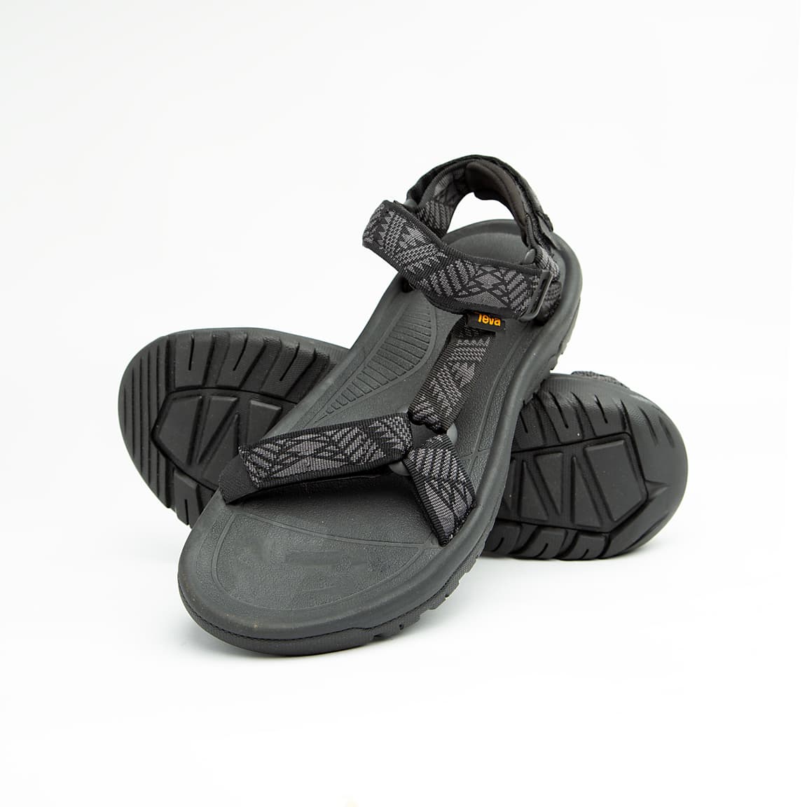 Black unisex outdoor sandals with patterned adjustable straps and rugged sole.