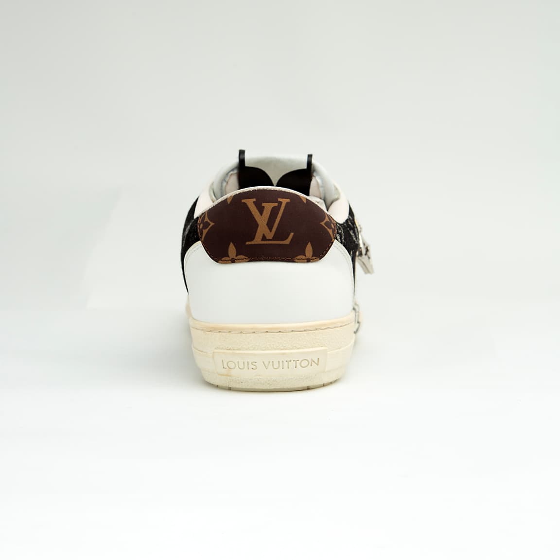 The Denim Riviera Ace is a high-fashion, low-top sneaker built on a classic court silhouette. It features a unique upper constructed from blue denim-style canvas or leather boldly printed with the recognizable Louis Vuitton Monogram pattern.
