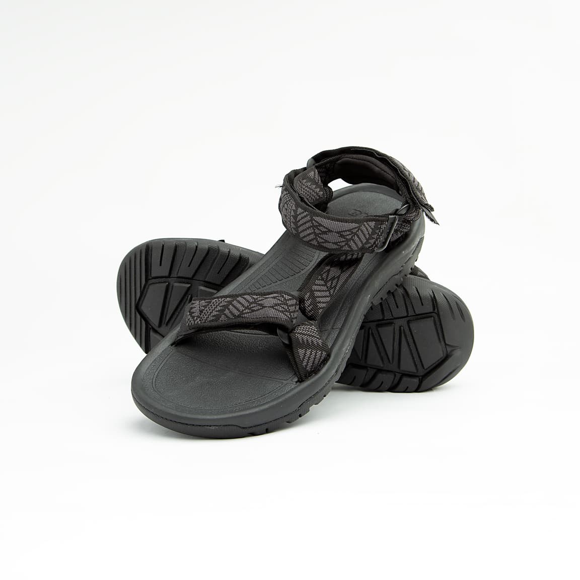 Black all-terrain unisex sport sandals with patterned adjustable straps and rugged rubber sole.