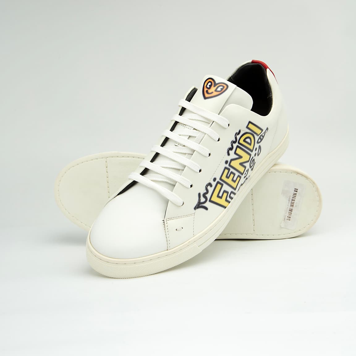 The White Tiger Skate Low is a clean, modern, low-top trainer with a luxury streetwear edge. It is crafted from smooth, premium white leather and features a distinctive black and white graphic drawing on the side panel, resembling a stylized tiger or abstract artwork.