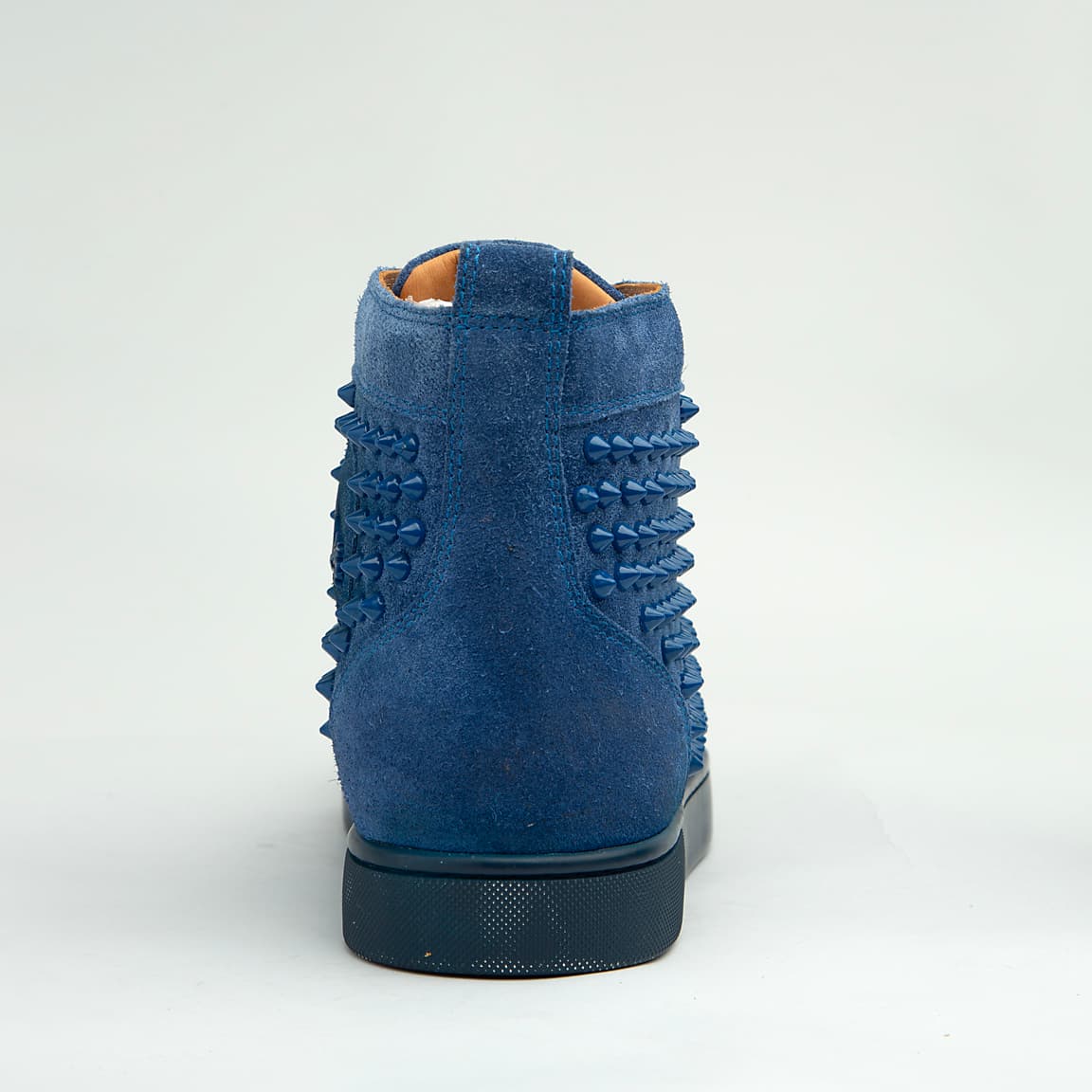 The Cobalt Studded Street is a defiant, high-top luxury sneaker designed for maximum statement impact.
