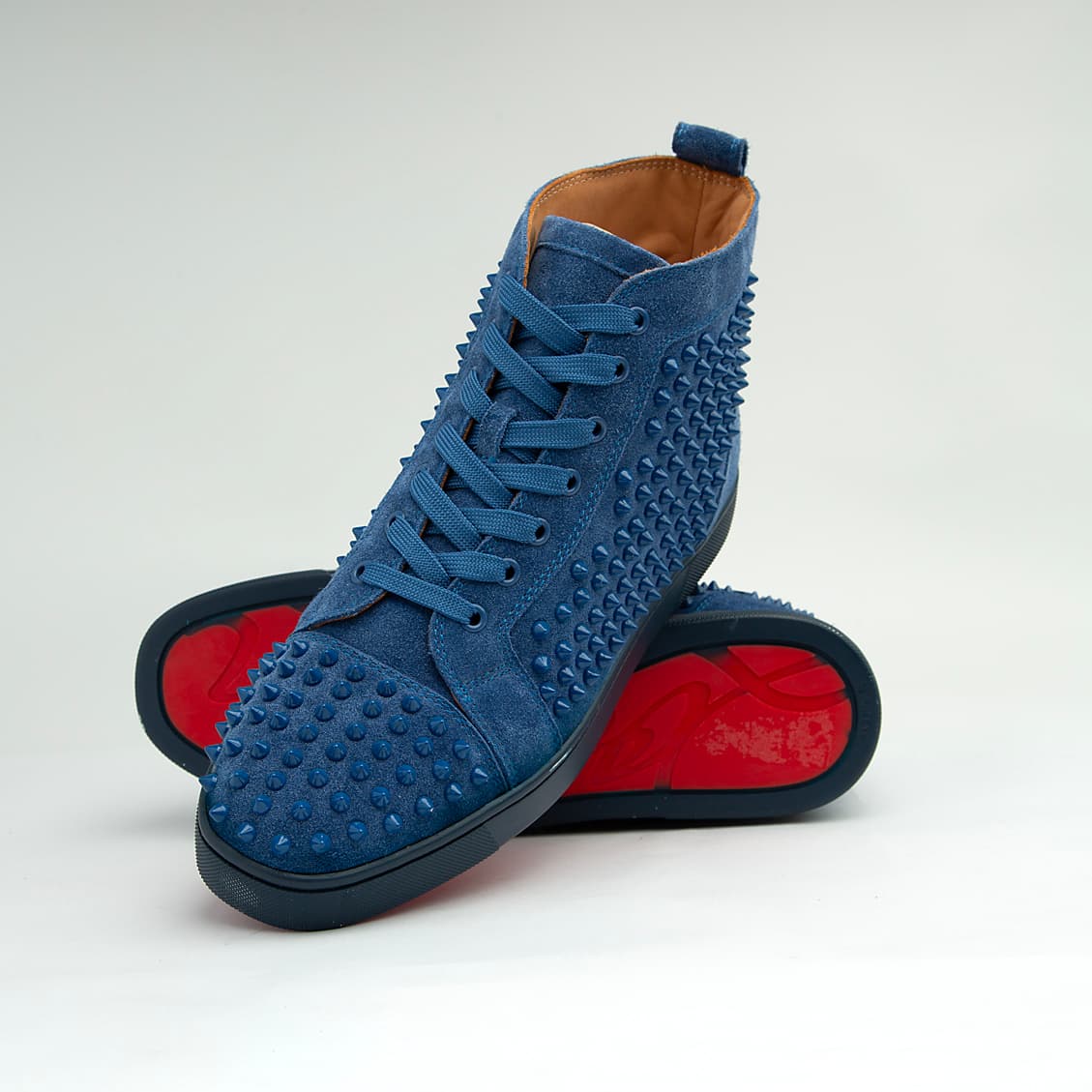 The Cobalt Studded Street is a defiant, high-top luxury sneaker designed for maximum statement impact.