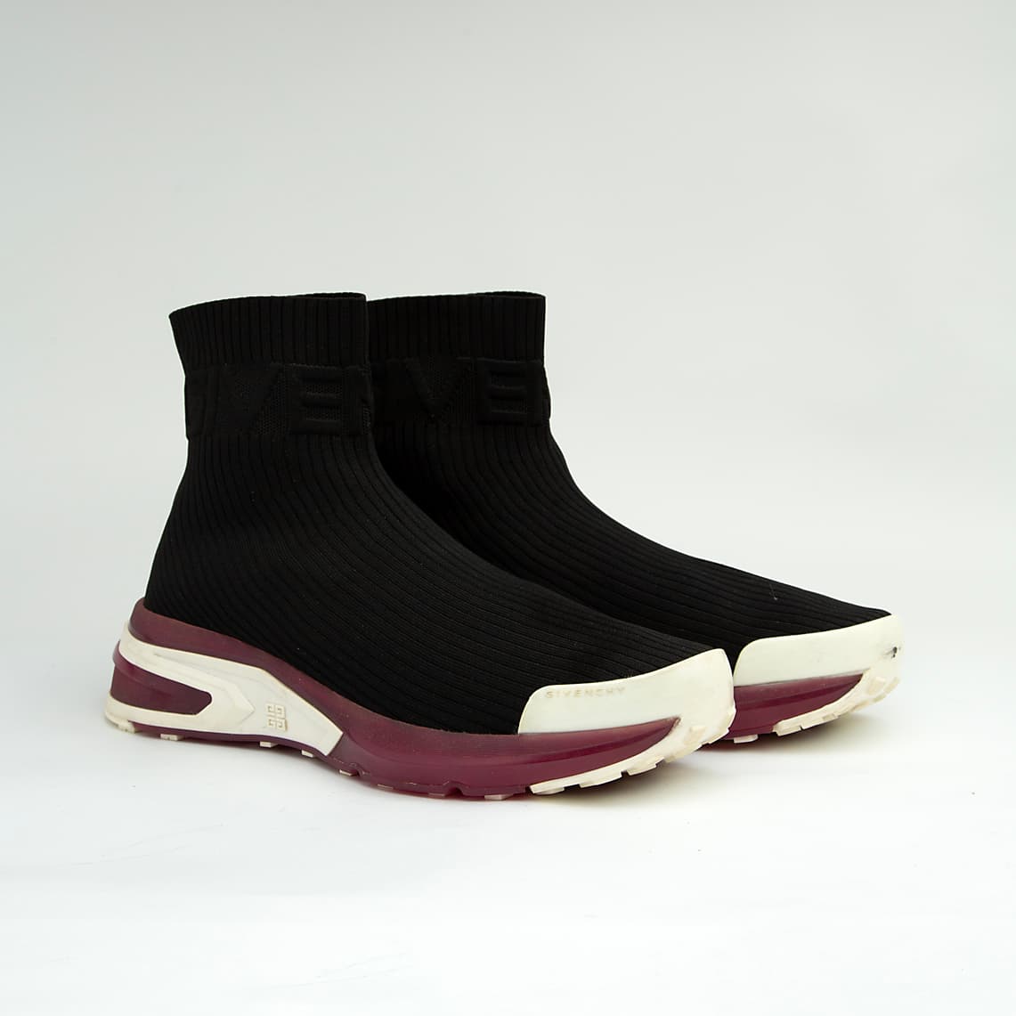 The Obsidian Sock Runner is a high-fashion, high-top sneaker characterized by its minimalist, slip-on design and bold, futuristic sole.