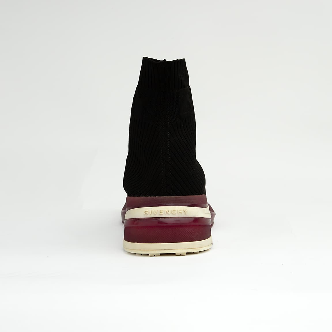 The Obsidian Sock Runner is a high-fashion, high-top sneaker characterized by its minimalist, slip-on design and bold, futuristic sole.