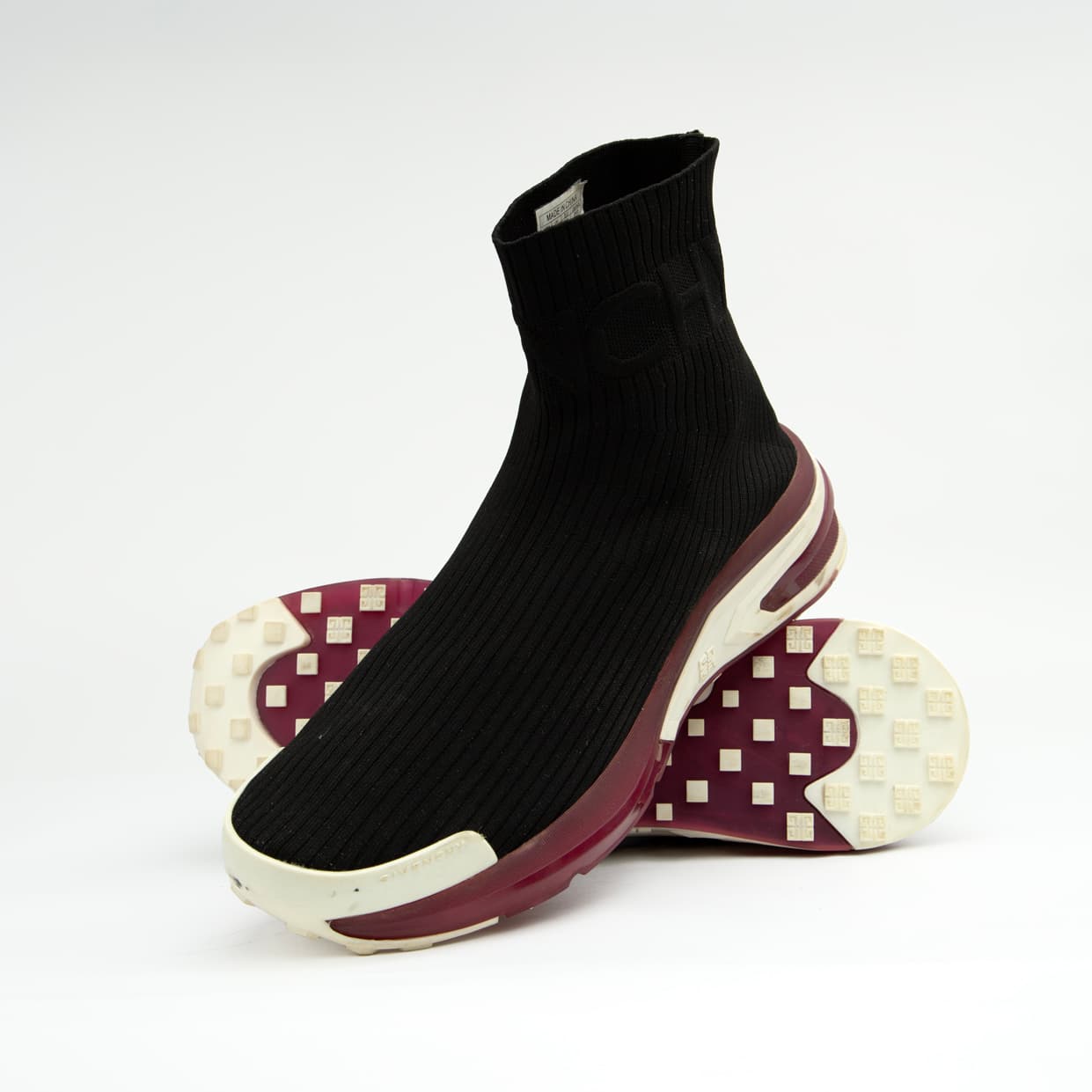 The Obsidian Sock Runner is a high-fashion, high-top sneaker characterized by its minimalist, slip-on design and bold, futuristic sole.