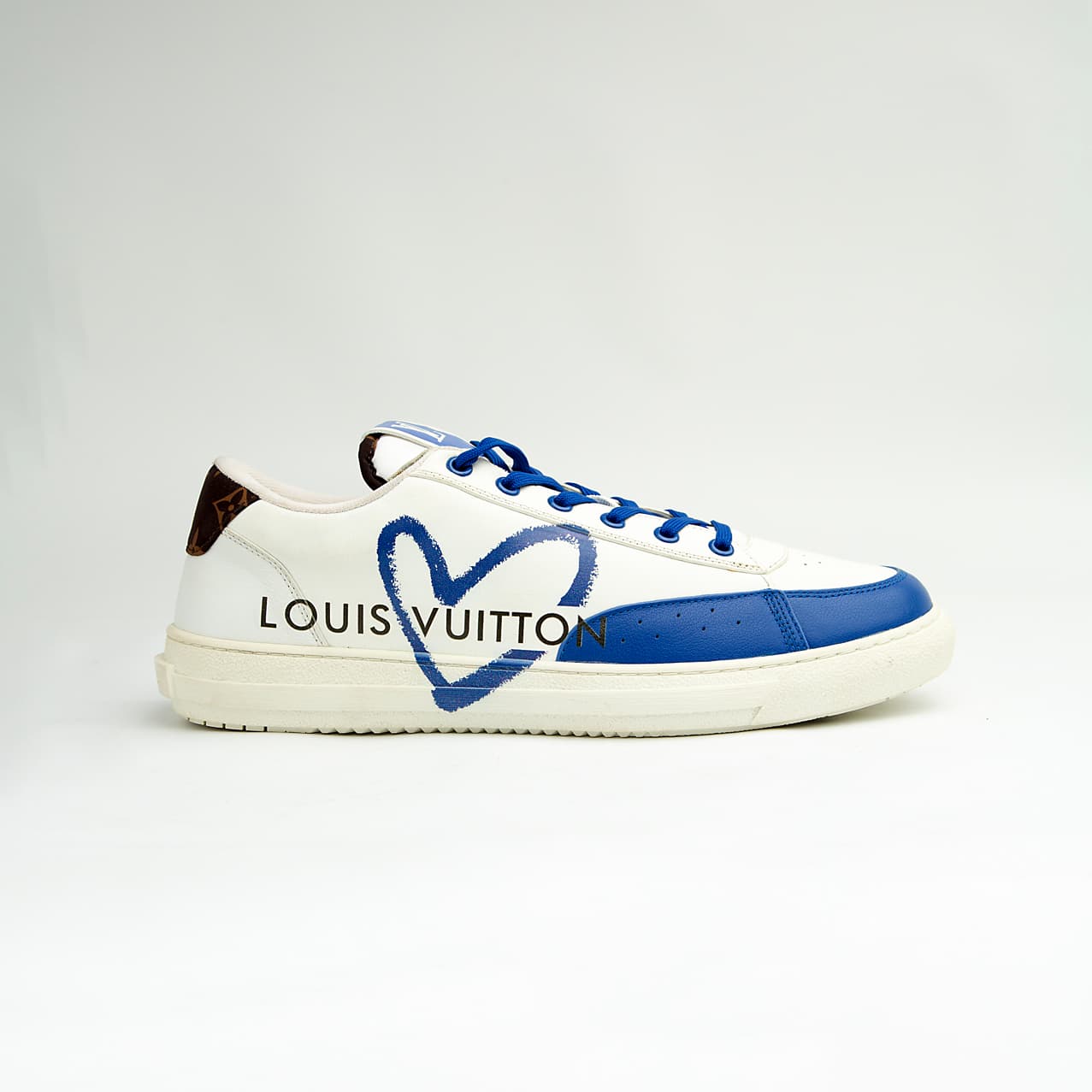 Louis Vuitton Blue Heart unisex sneakers with white leather base, blue detailing, and LV heart design — luxury designer footwear.