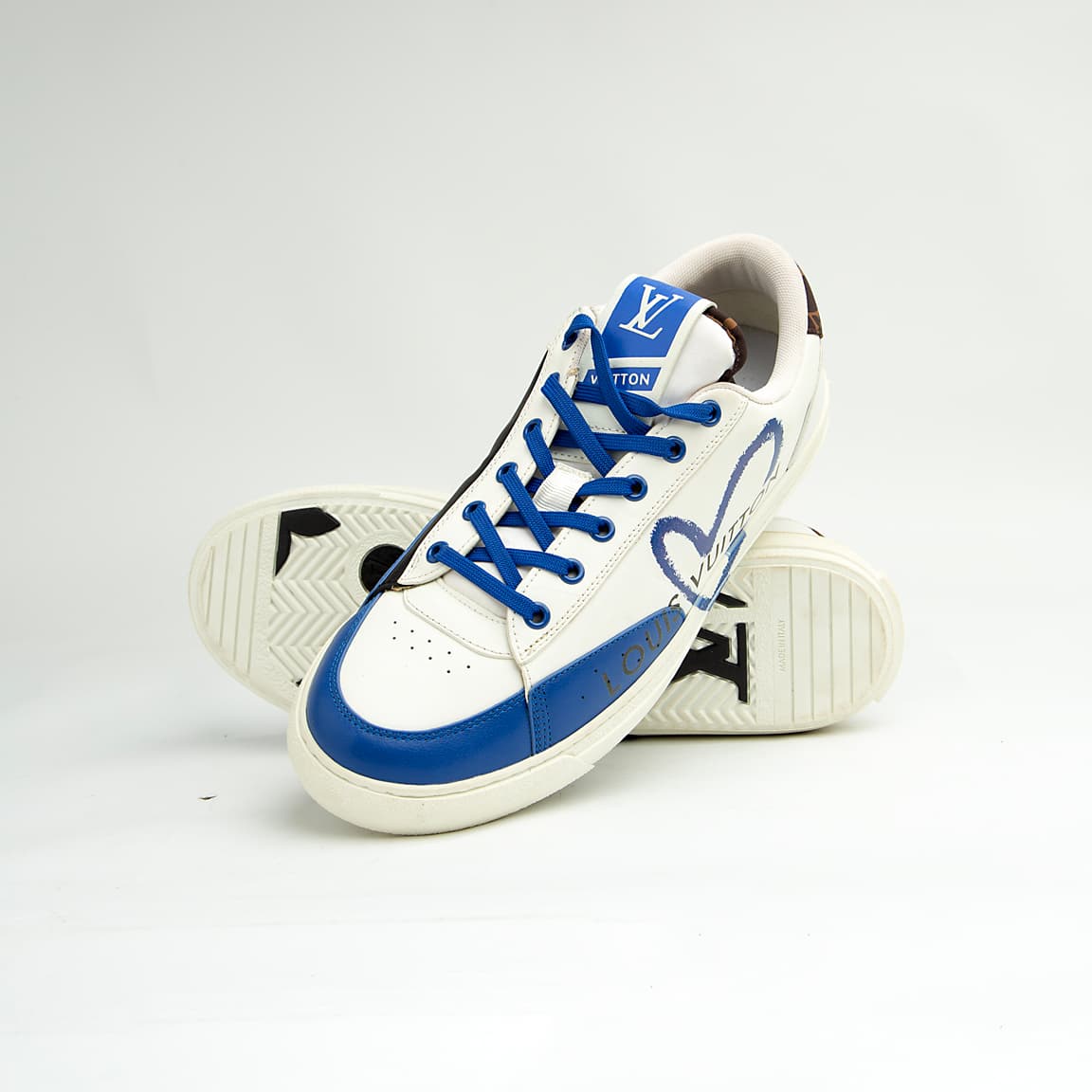 Louis Vuitton Blue Heart unisex sneakers with white leather base, blue detailing, and LV heart design — luxury designer footwear.