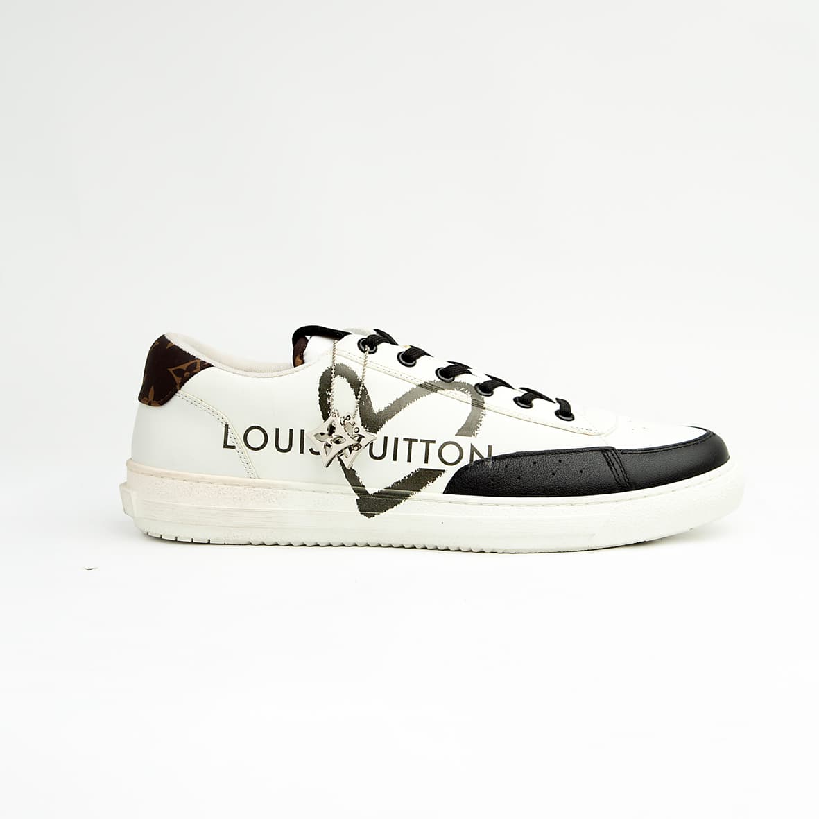 Louis Vuitton Black Heart unisex sneakers in white and black leather with LV heart motif and logo charm — luxury designer footwear.