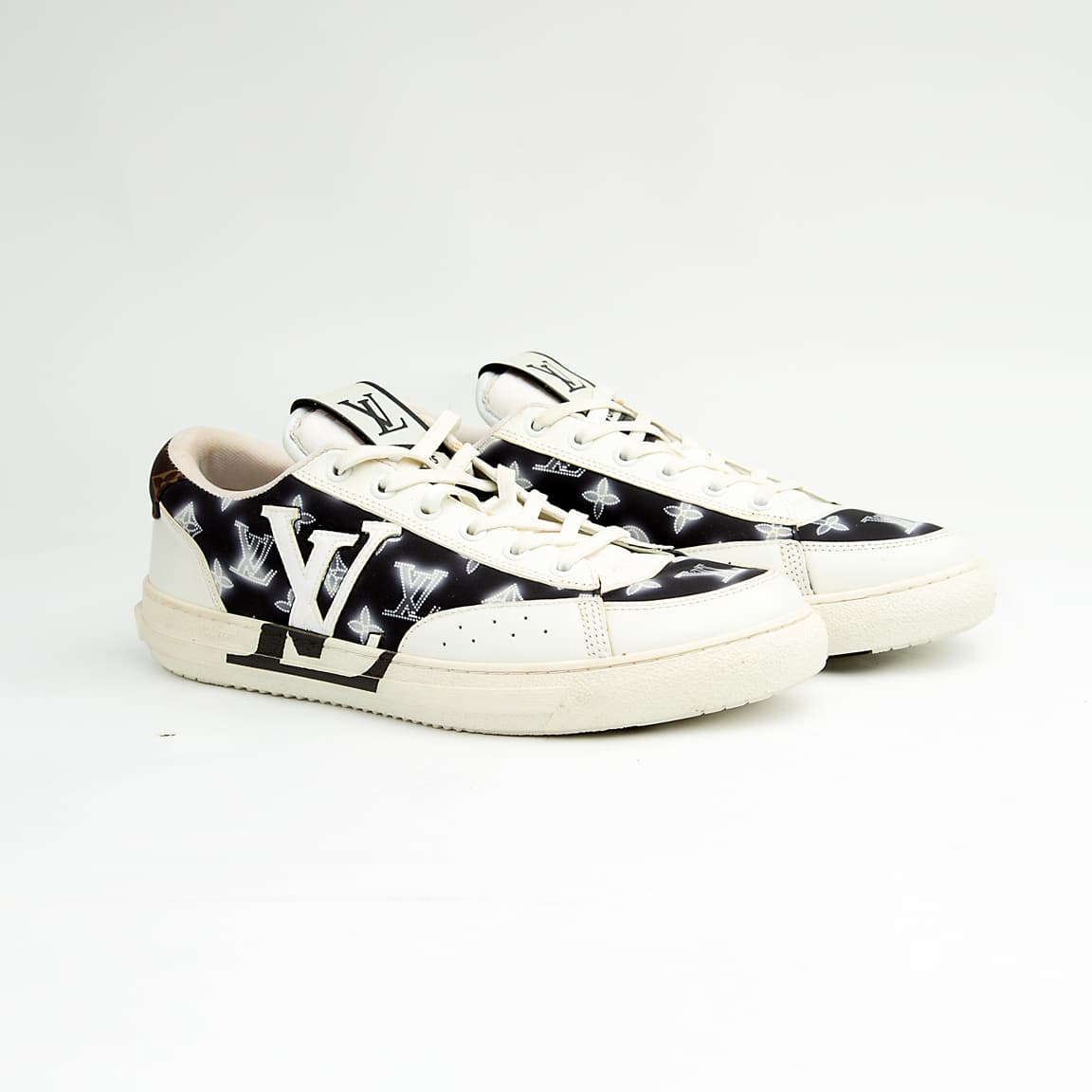 Louis Vuitton black and white unisex sneakers with large LV logo and monogram pattern, luxury designer court shoes.