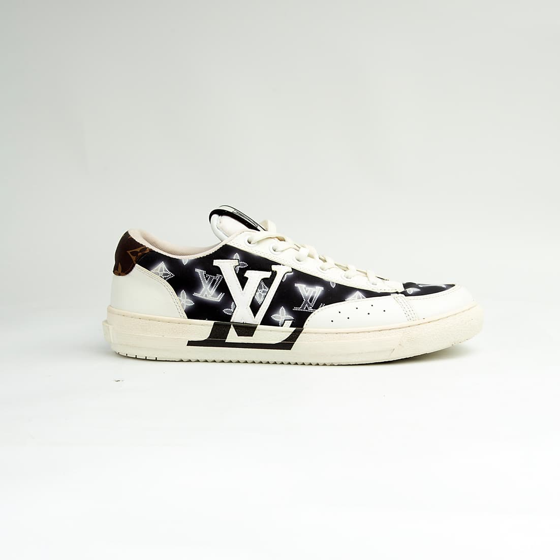 Louis Vuitton black and white unisex sneakers with large LV logo and monogram pattern, luxury designer court shoes.