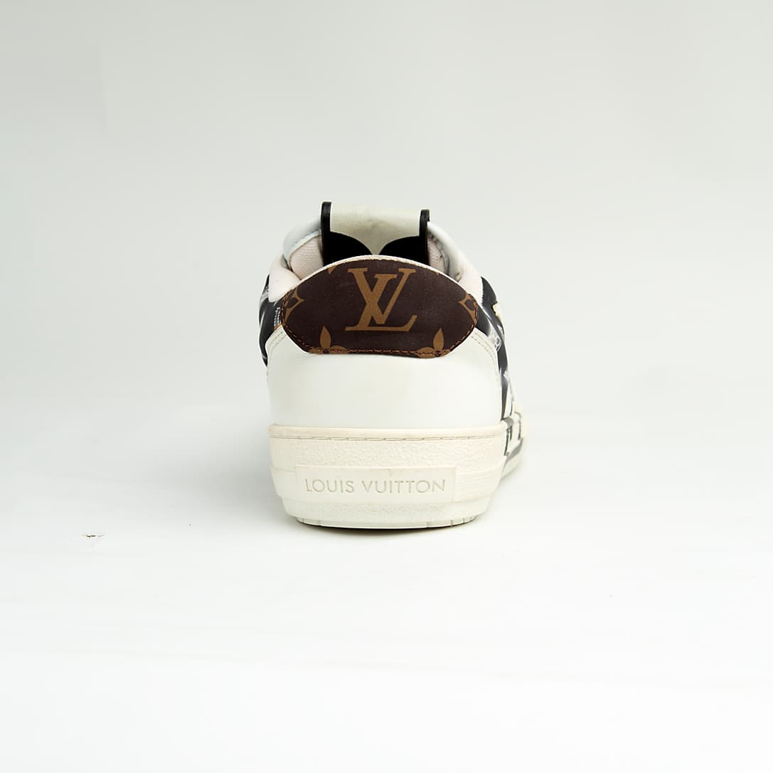 Louis Vuitton black and white unisex sneakers with large LV logo and monogram pattern, luxury designer court shoes.