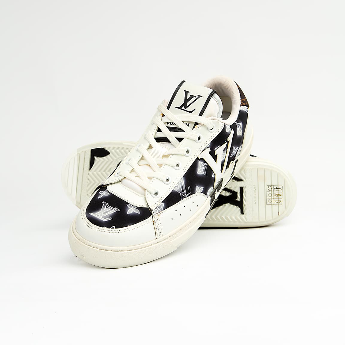 Louis Vuitton black and white unisex sneakers with large LV logo and monogram pattern, luxury designer court shoes.