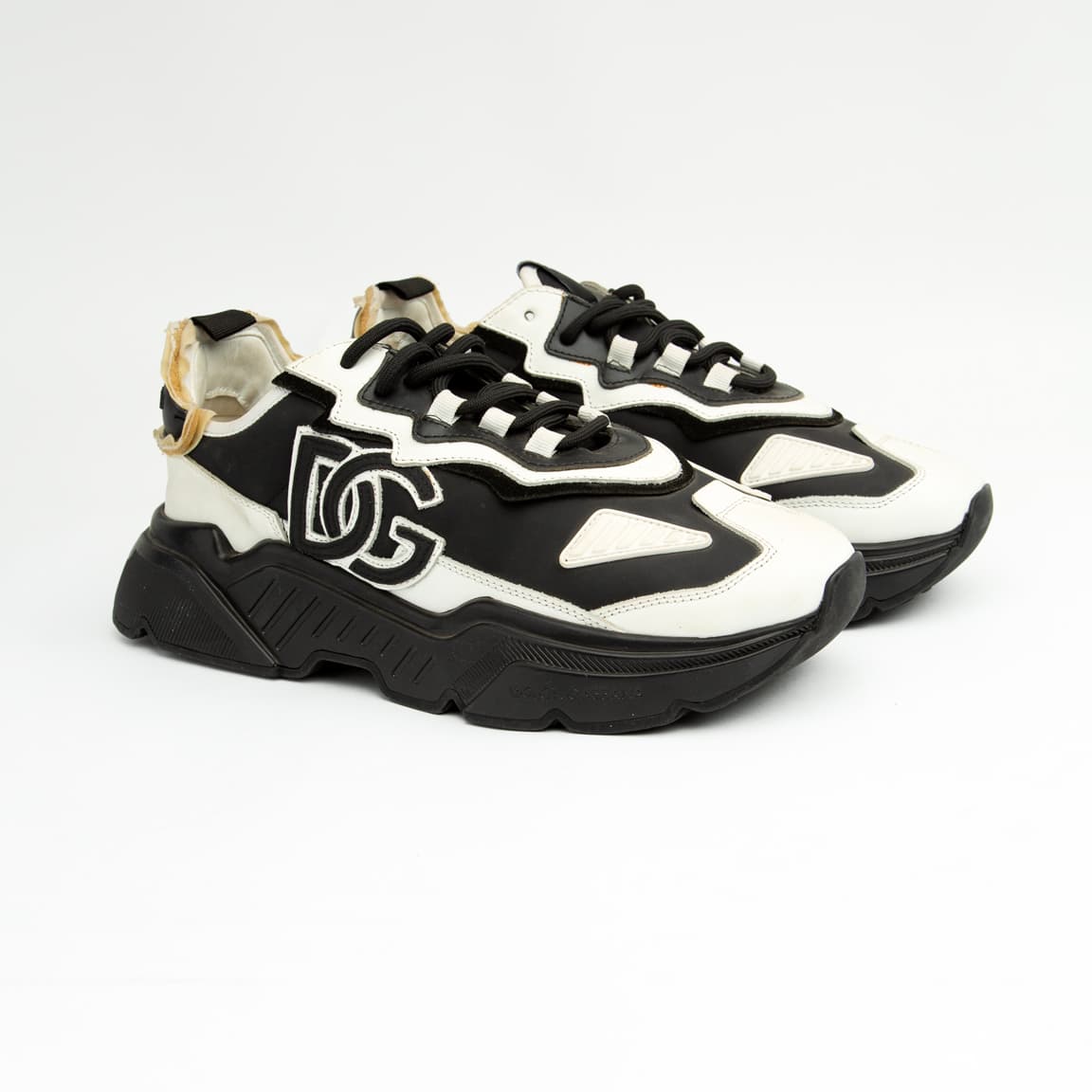 Monochrome chunky black and white unisex sneakers with bold DG-style design and thick sole.