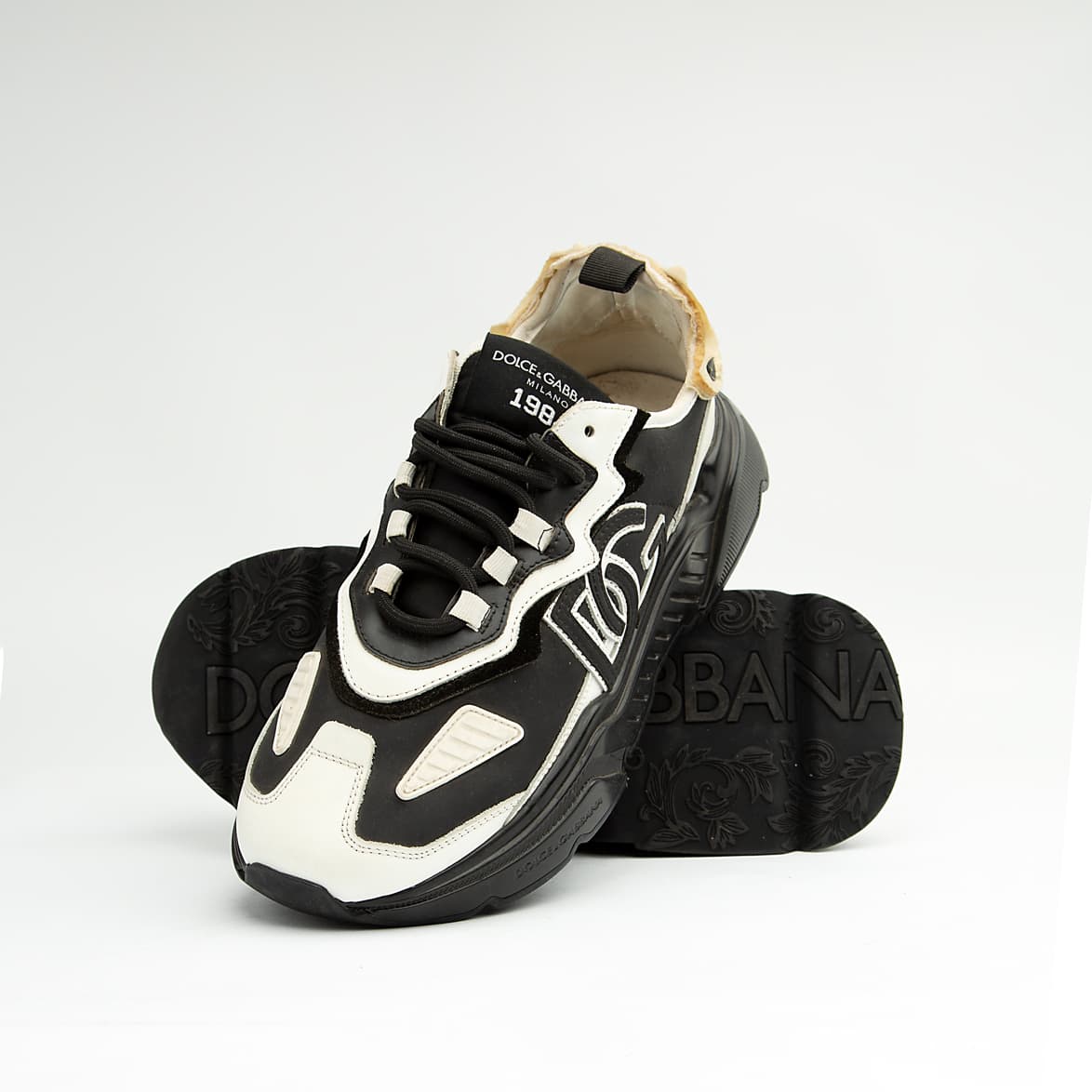 Monochrome chunky black and white unisex sneakers with bold DG-style design and thick sole.