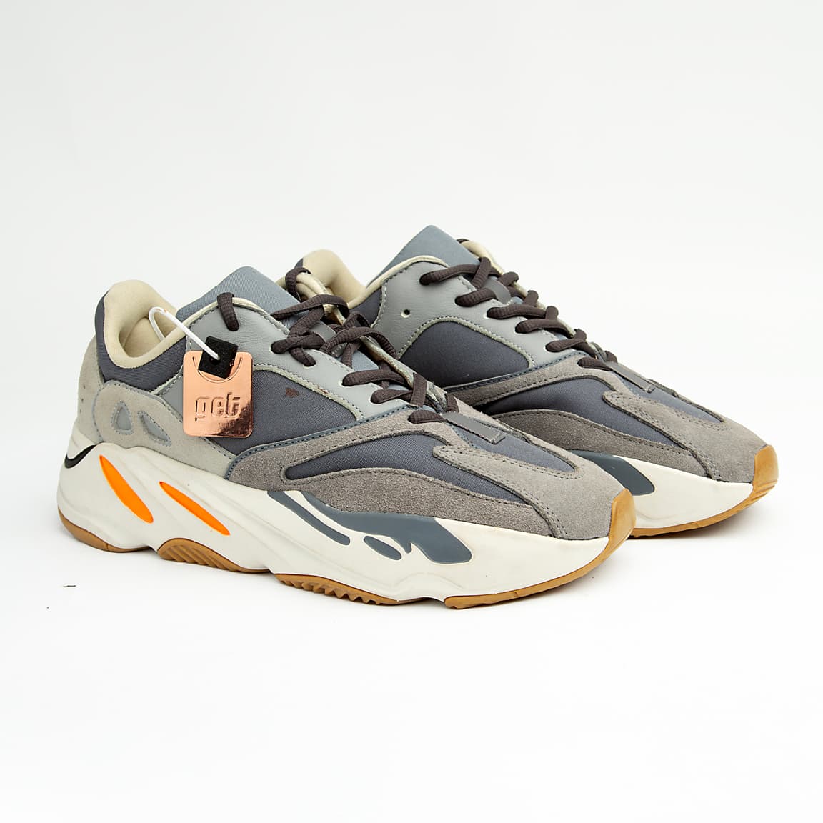 Grey and orange unisex chunky retro sneakers with suede, mesh, and leather detailing.
