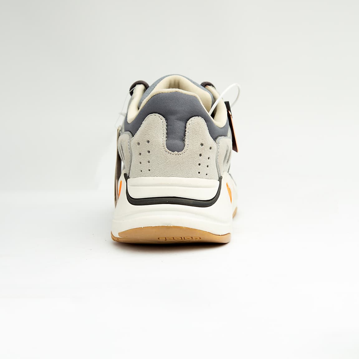 Grey and orange unisex chunky retro sneakers with suede, mesh, and leather detailing.