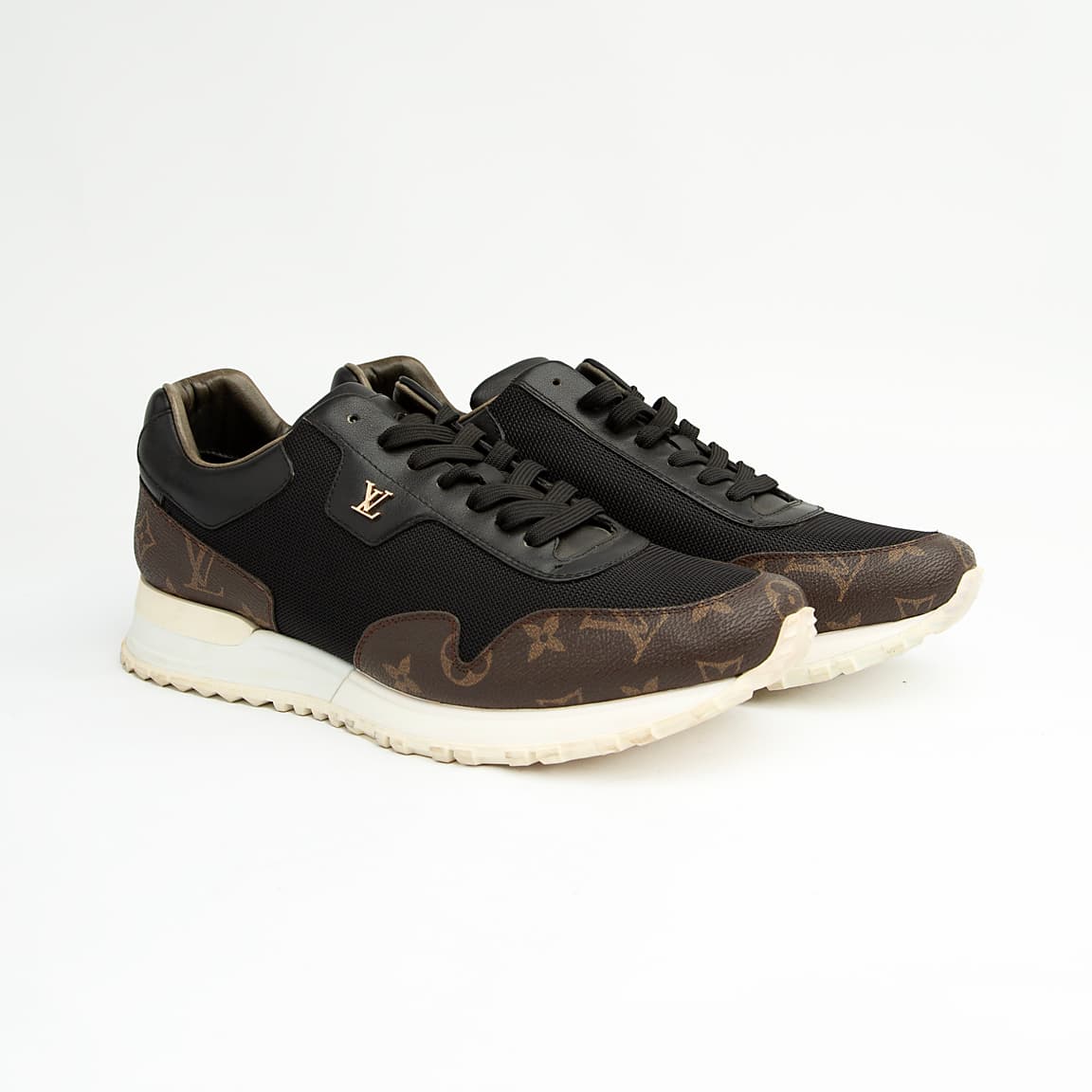 Luxury black and brown Louis Vuitton monogram unisex sneakers with white sole and gold LV logo.