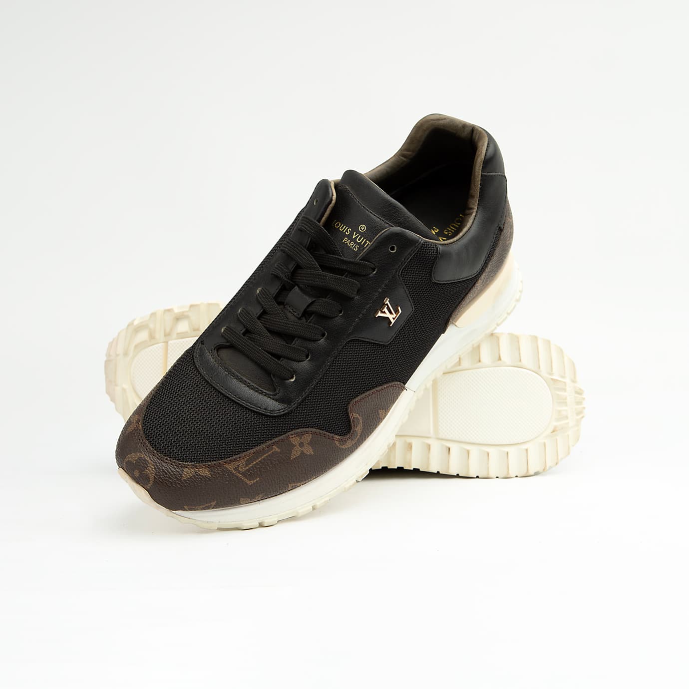 Luxury black and brown Louis Vuitton monogram unisex sneakers with white sole and gold LV logo.