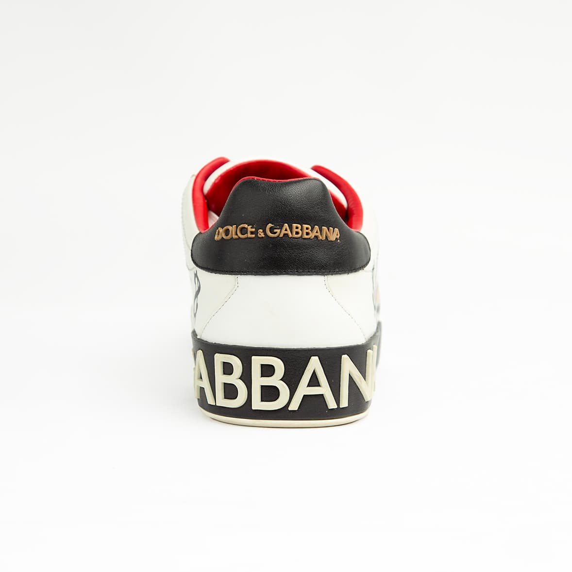 These pristine white leather sneakers are elevated by unique, vibrant hand-painted-style graphics, including the playful "Banker Pig" figure in a tuxedo, stylized money symbols, and bold star accents.