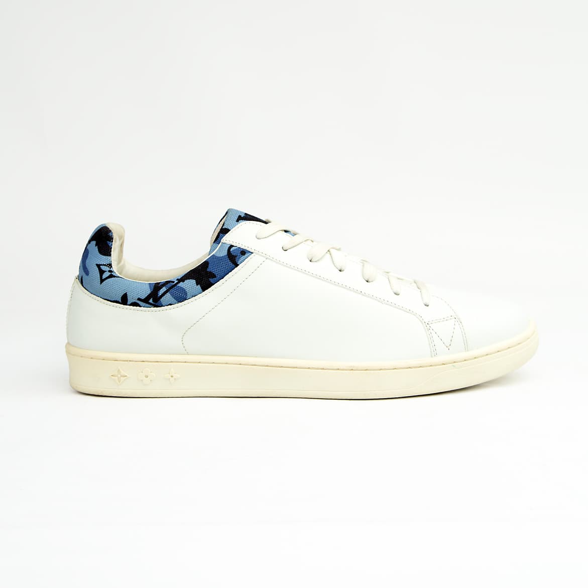 White Louis Vuitton unisex sneakers with blue monogram denim detail and white sole.
