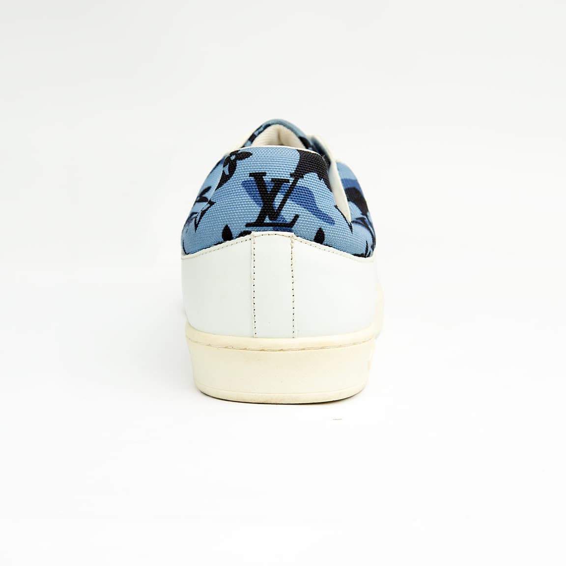 White Louis Vuitton unisex sneakers with blue monogram denim detail and white sole.