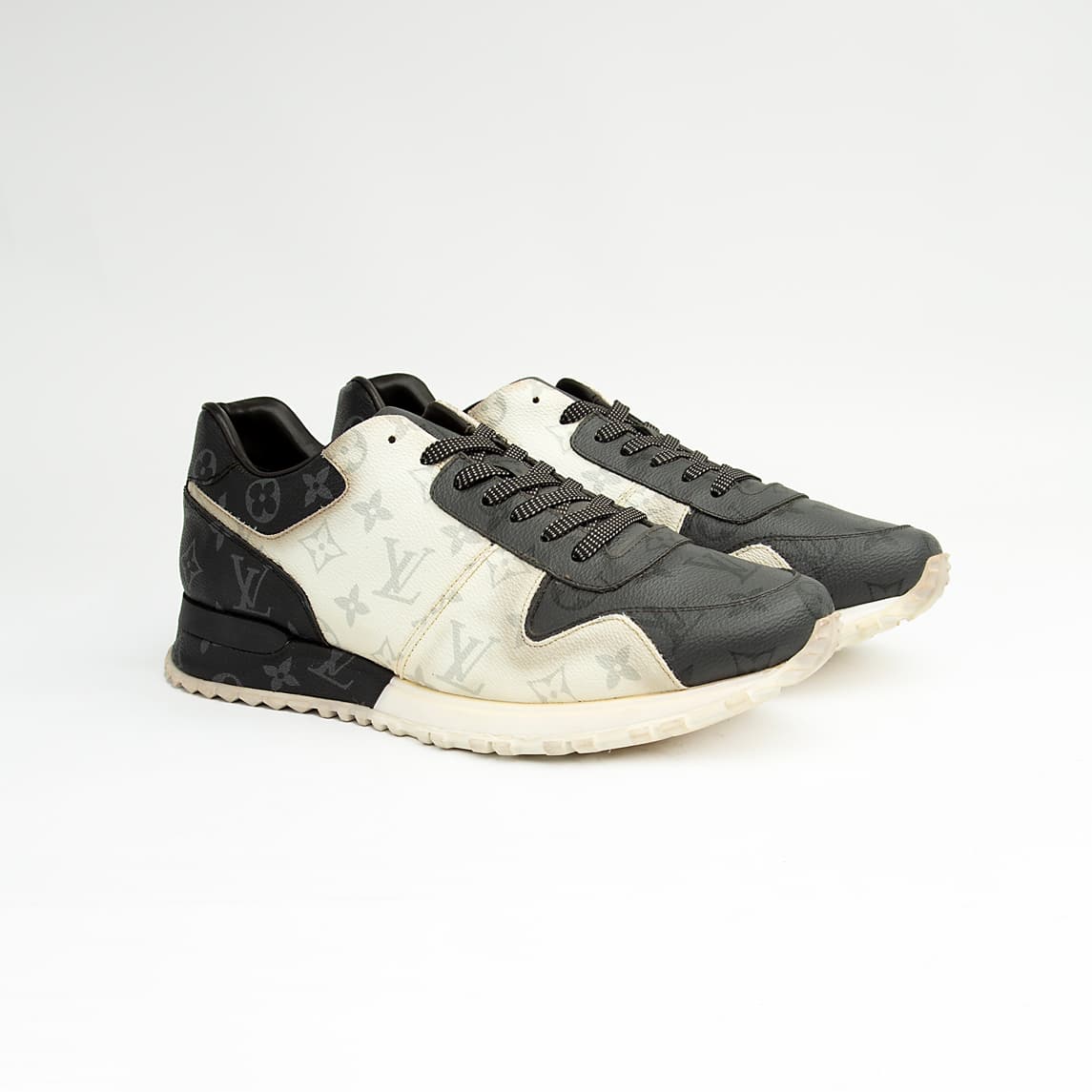 Louis Vuitton black and white unisex sneakers with monogram eclipse design and white sole.