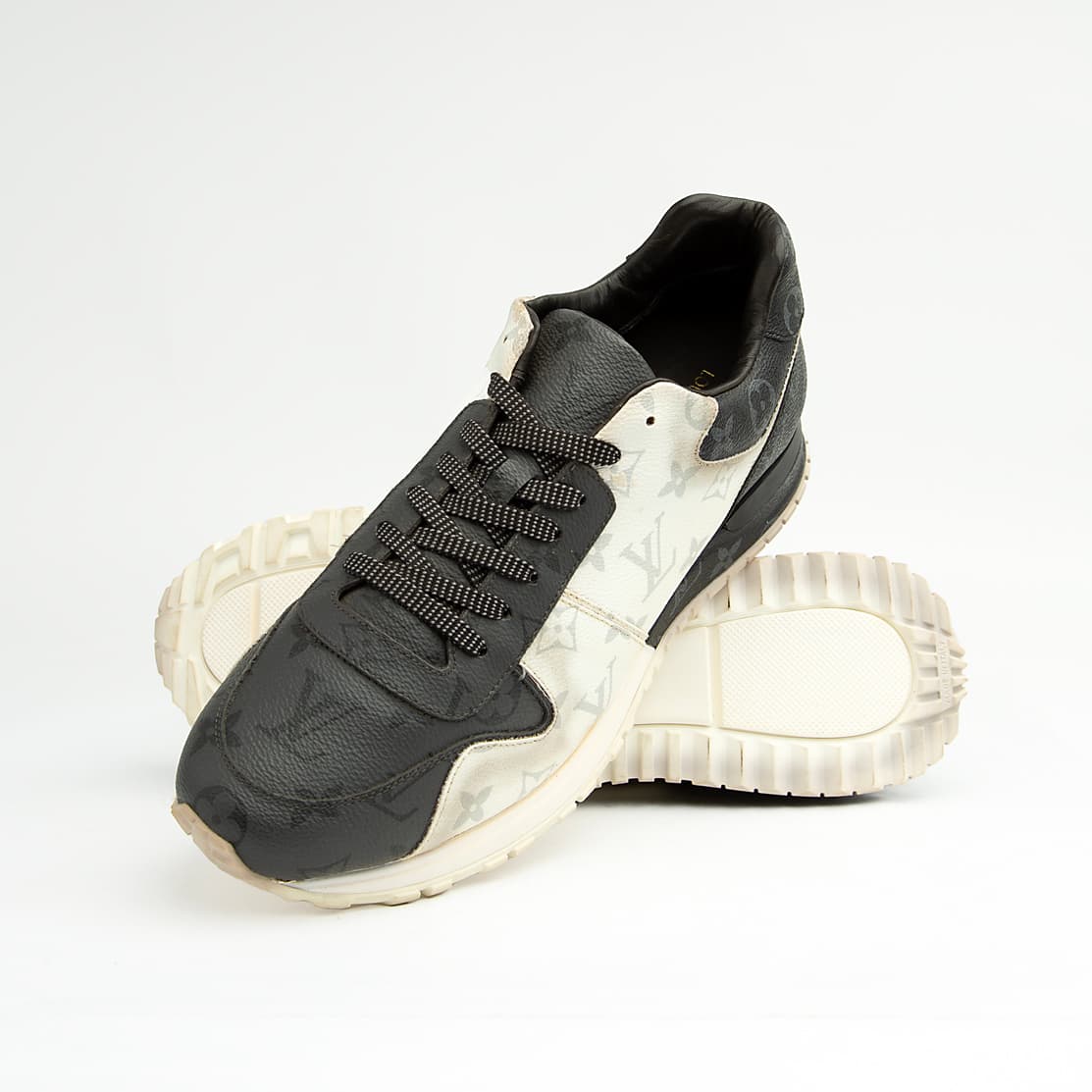 Louis Vuitton black and white unisex sneakers with monogram eclipse design and white sole.