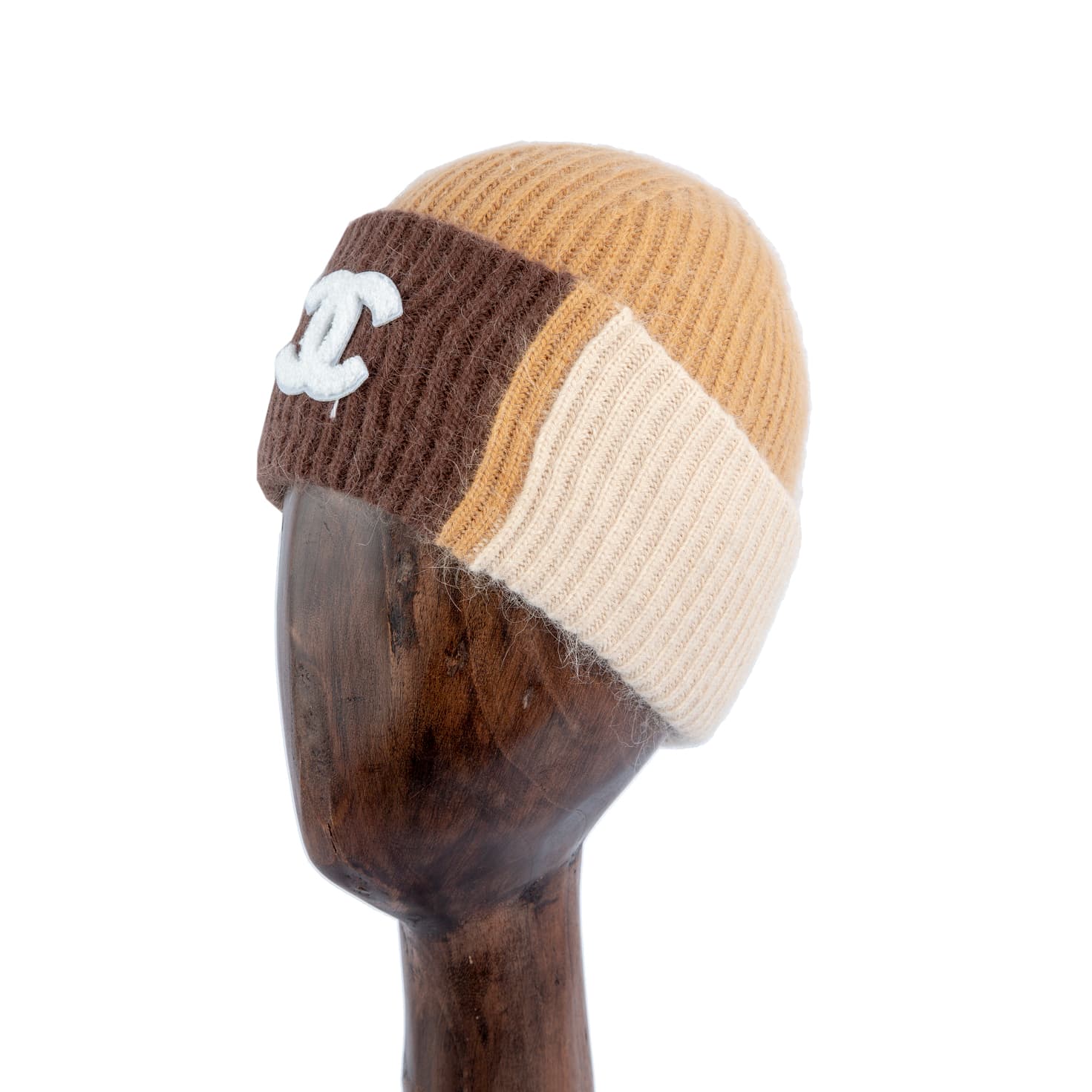 Multi-tone wool beanie in brown, beige, and camel with white logo.