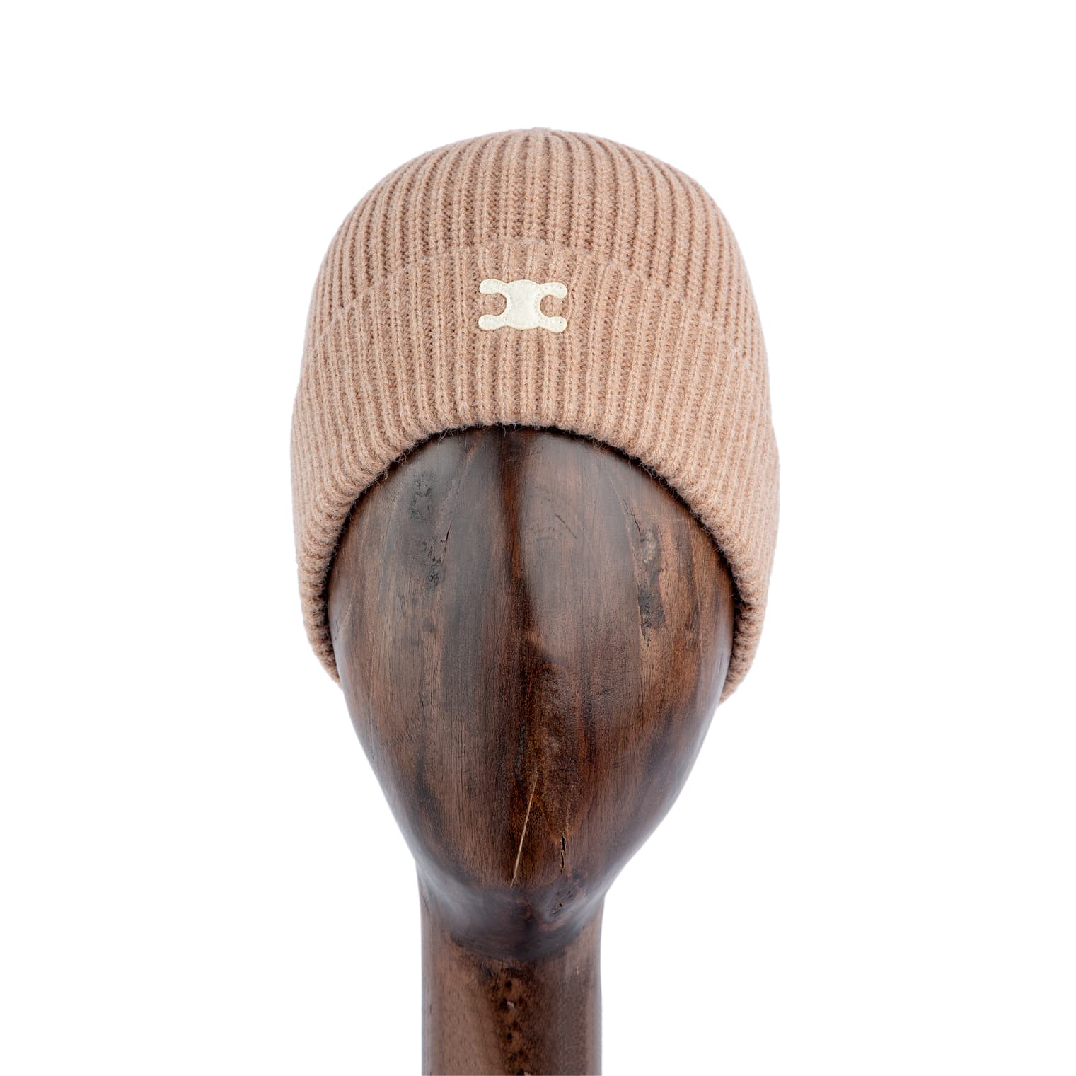 Ribbed camel brown knit beanie with metallic logo, stylish winter hat on wooden stand