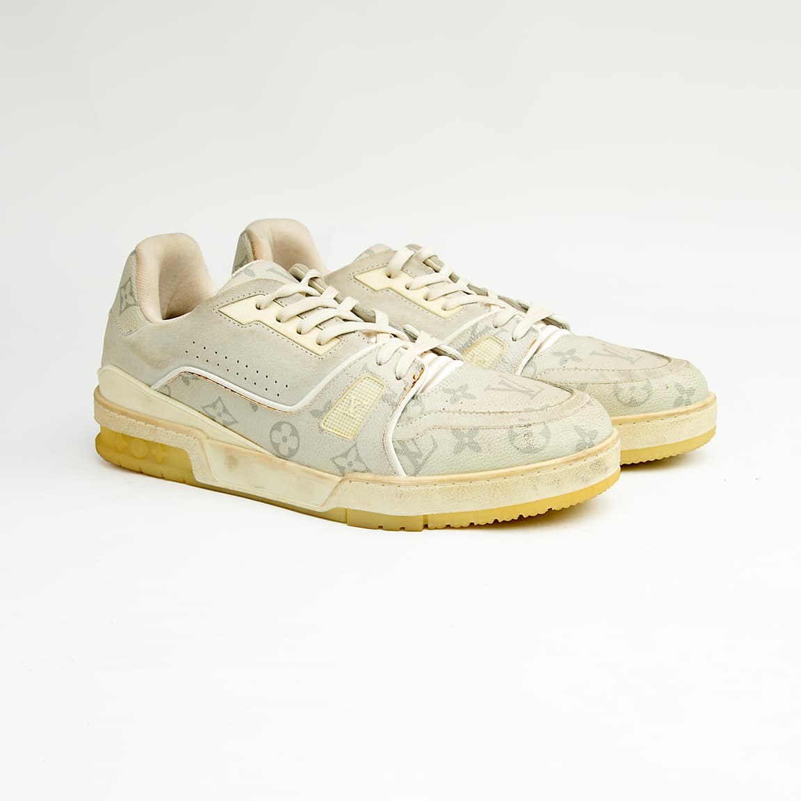 Cream monogram low-top unisex sneakers with retro sole and soft leather detailing.