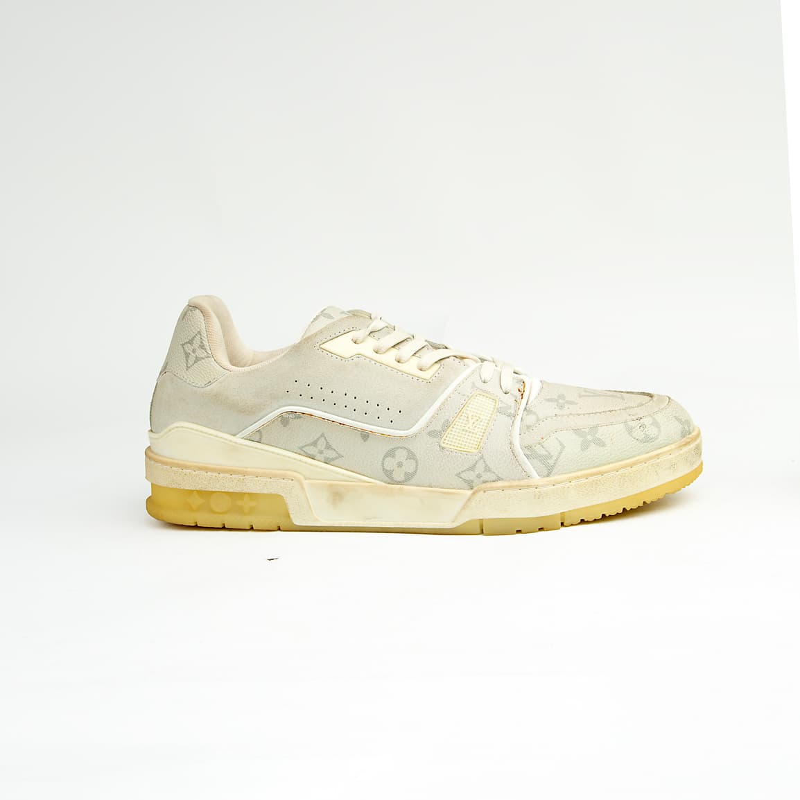 Cream monogram low-top unisex sneakers with retro sole and soft leather detailing.