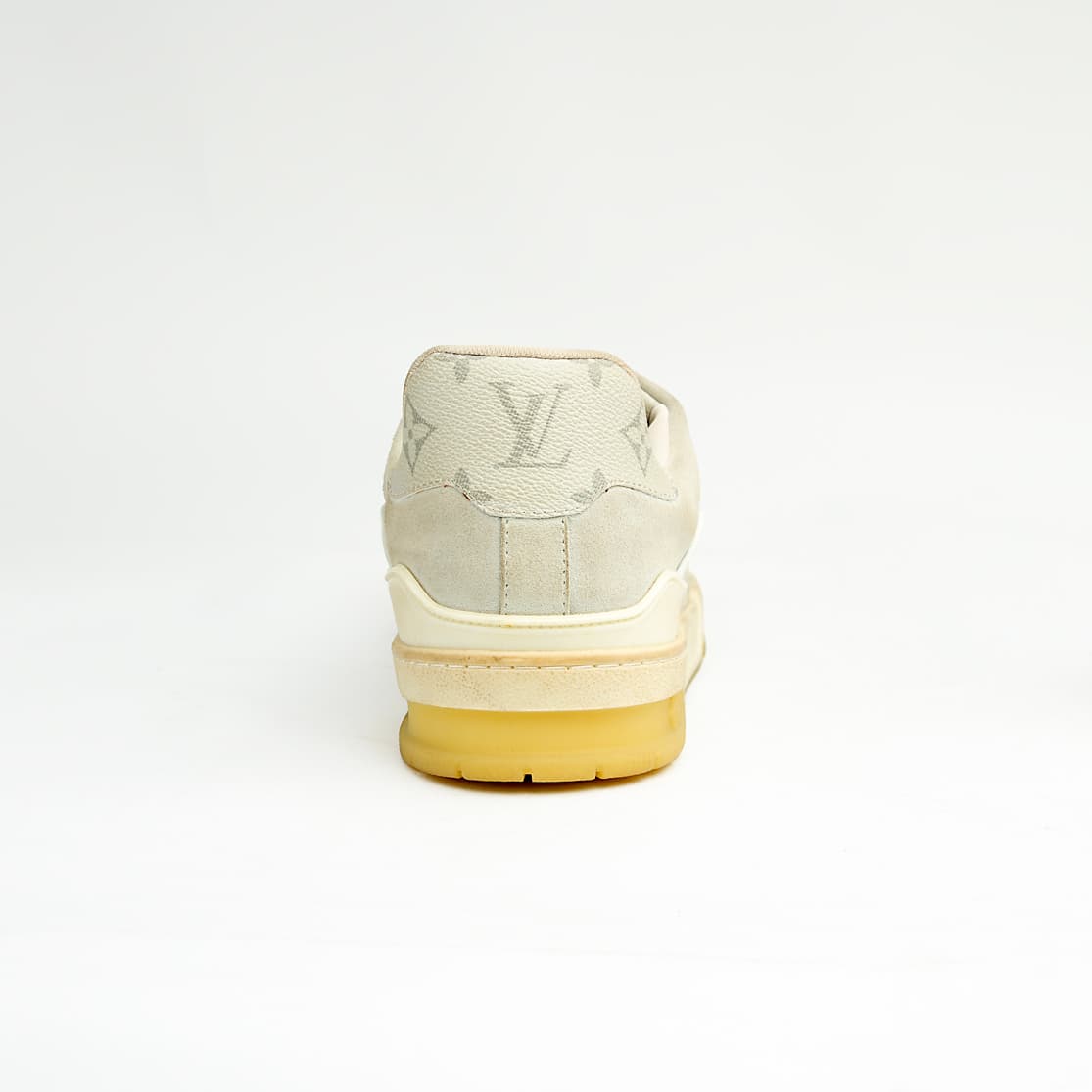Cream monogram low-top unisex sneakers with retro sole and soft leather detailing.