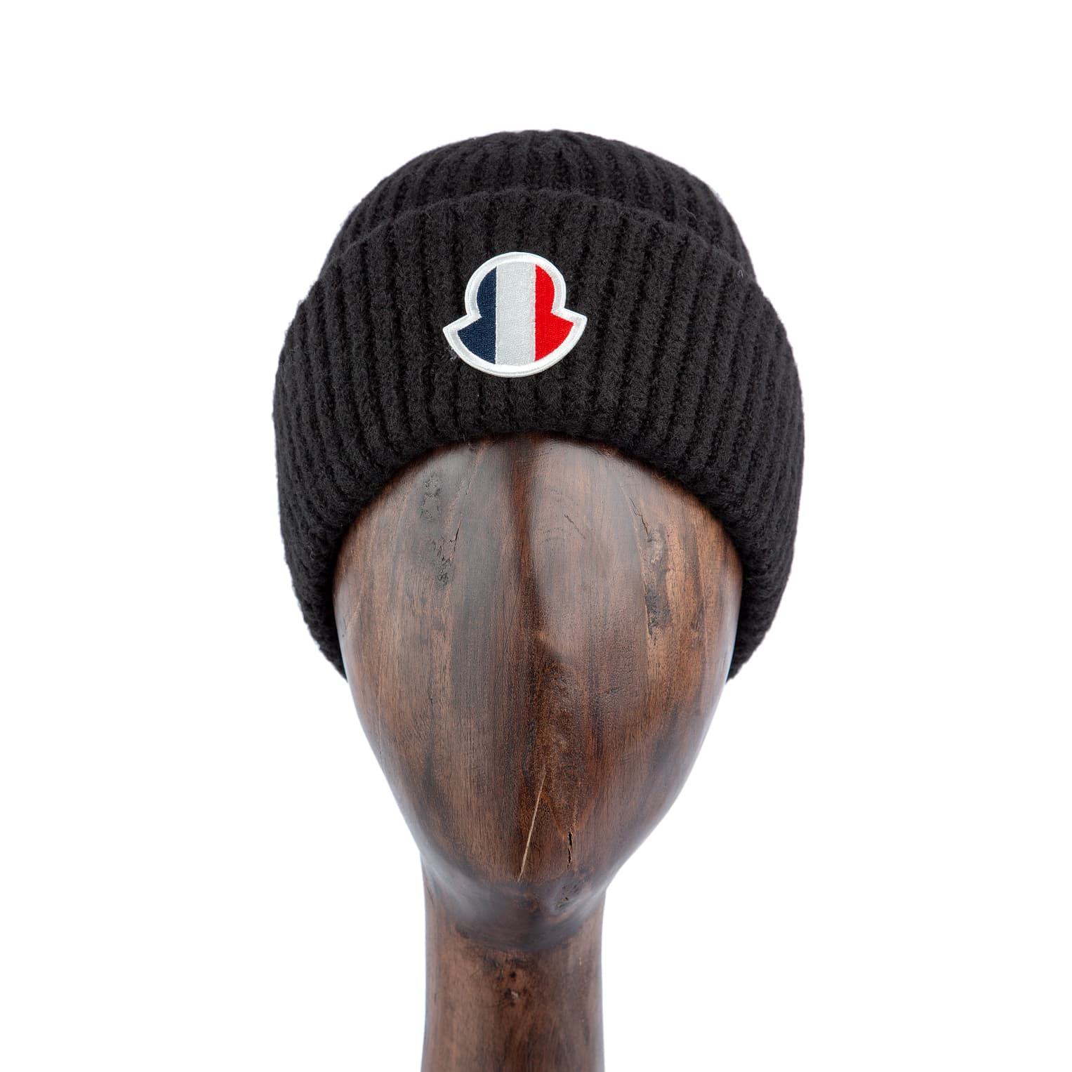 Black wool beanie with ribbed knit texture and tricolor logo patch for a stylish and cozy winter accessory.