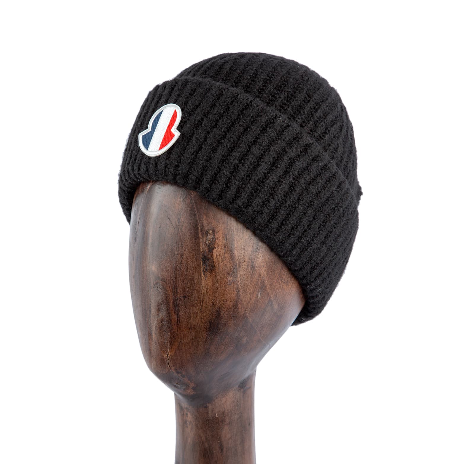 Black wool beanie with ribbed knit texture and tricolor logo patch for a stylish and cozy winter accessory.